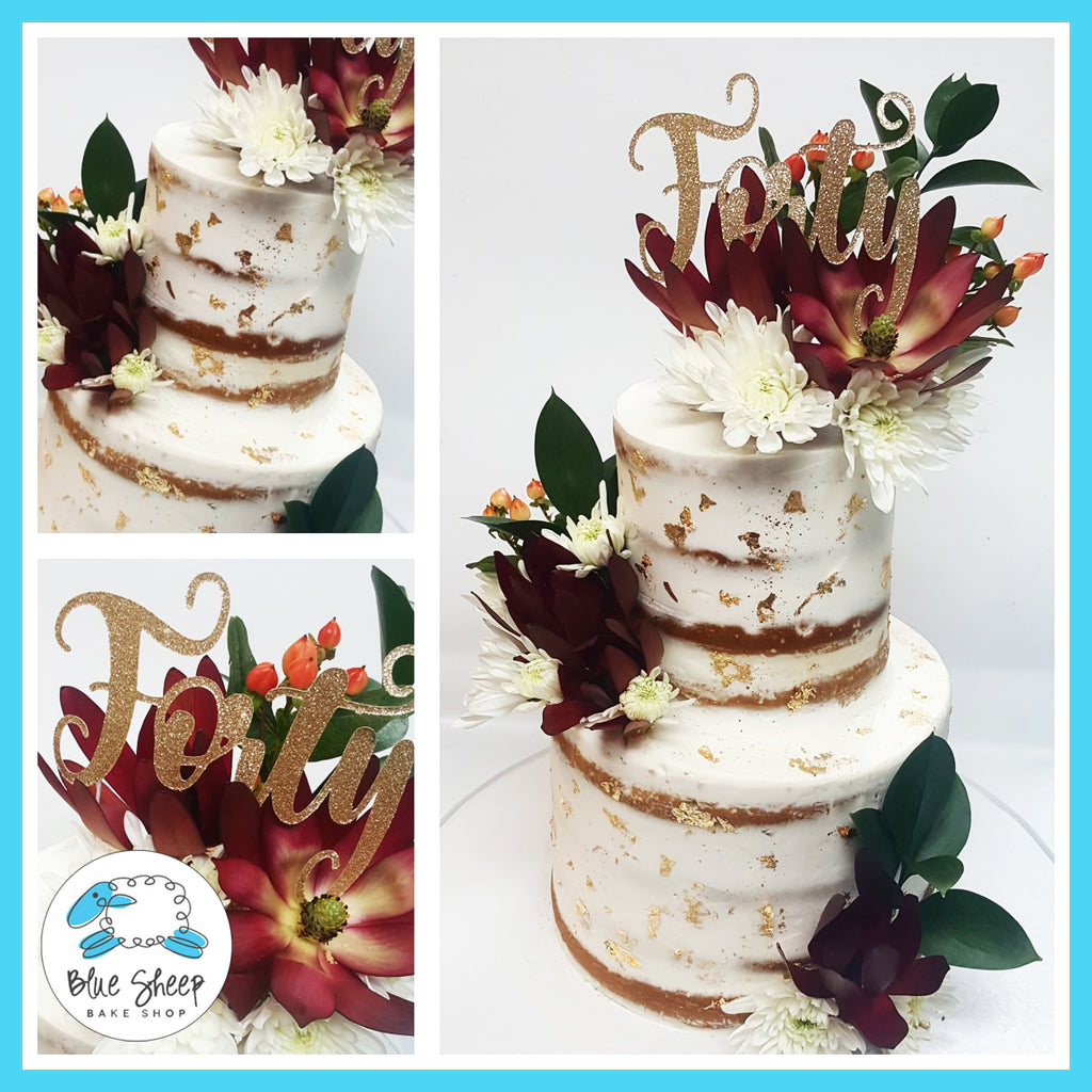 naked wedding cake with gold leaf and fresh fall blooms nj